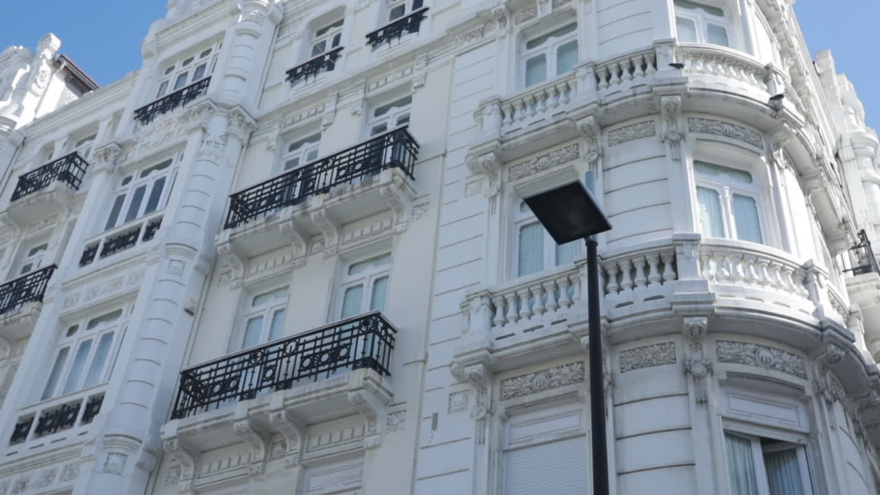 Elegant white building with intricate architecture under a bright blue sky