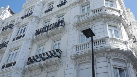 elegant white building with intricate architecture under a bright blue sky