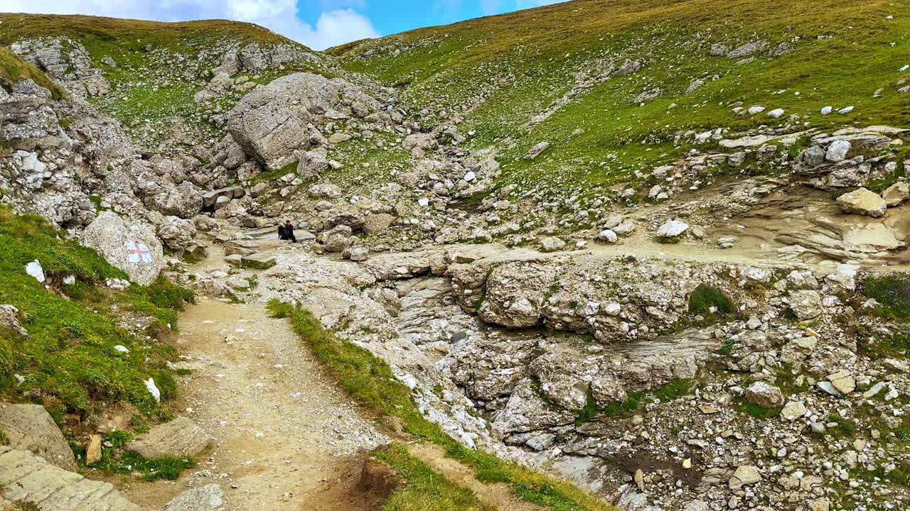 Walking by the trails in the Bucegi Mountains. Meeting two tourists hiking by the rocks. Southern Carpathians, Romania