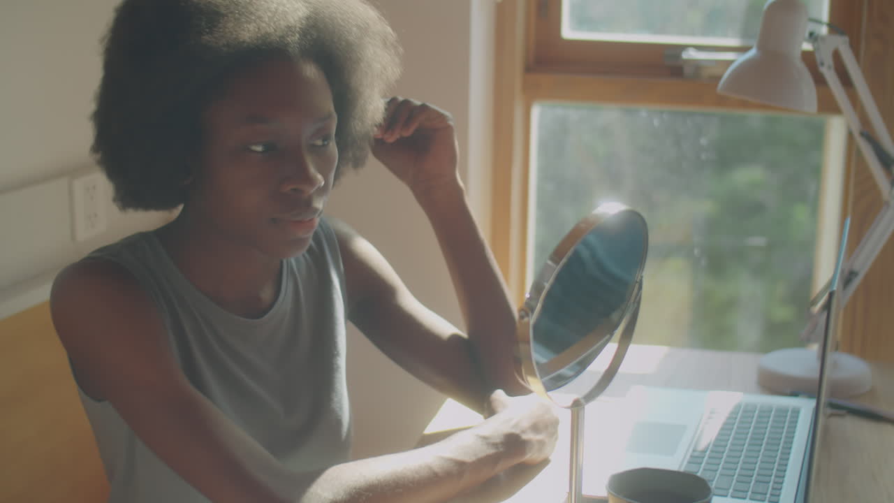 Woman Looking in Mirror at Home