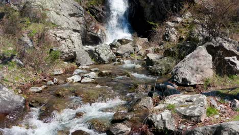 Slow-reveal-of-a-beautiful-waterfall-surrounded-by-rocks