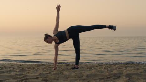 girl making ardha chandrasana standing beach. woman practicing half moon pose.