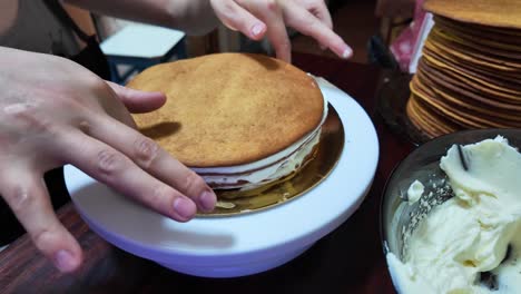 final touches in decorating the cake with white frosting