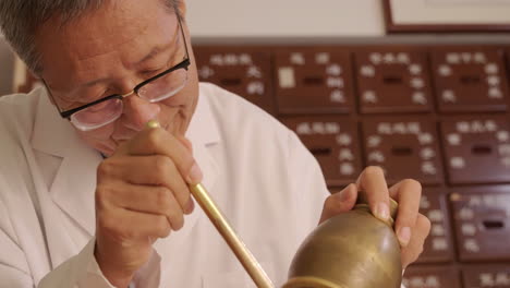 close-up treatment practitioner of traditional chinese medicine preparing herbal remedies, highlighting the ancient wisdom of holistic healing