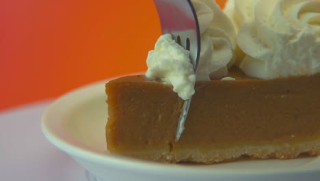 [camera used: canon c300] macro shot of a fork taking a bite out of a pumpkin pie slice