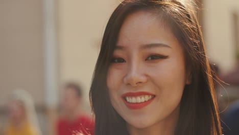 Close-Up-Of-The-Pretty-Brunette-Young-Girl-Smiling-Happily-To-The-Camera-In-Sunlight-On-Summer-Day