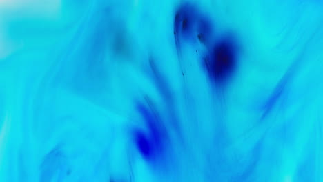 turquoise and blue paint or dye dropped into water against white background to create swirling colourful smoke background 1