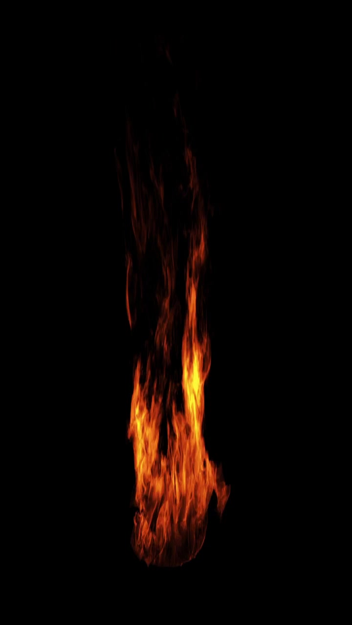 Vertical burst of orange flames igniting against a black background
