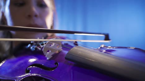 Close-up-of-musician-playing-violin-on-stage.