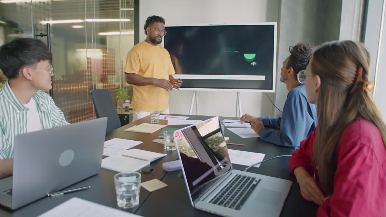 Businessman Giving Presentation on Interactive Screen at Meeting