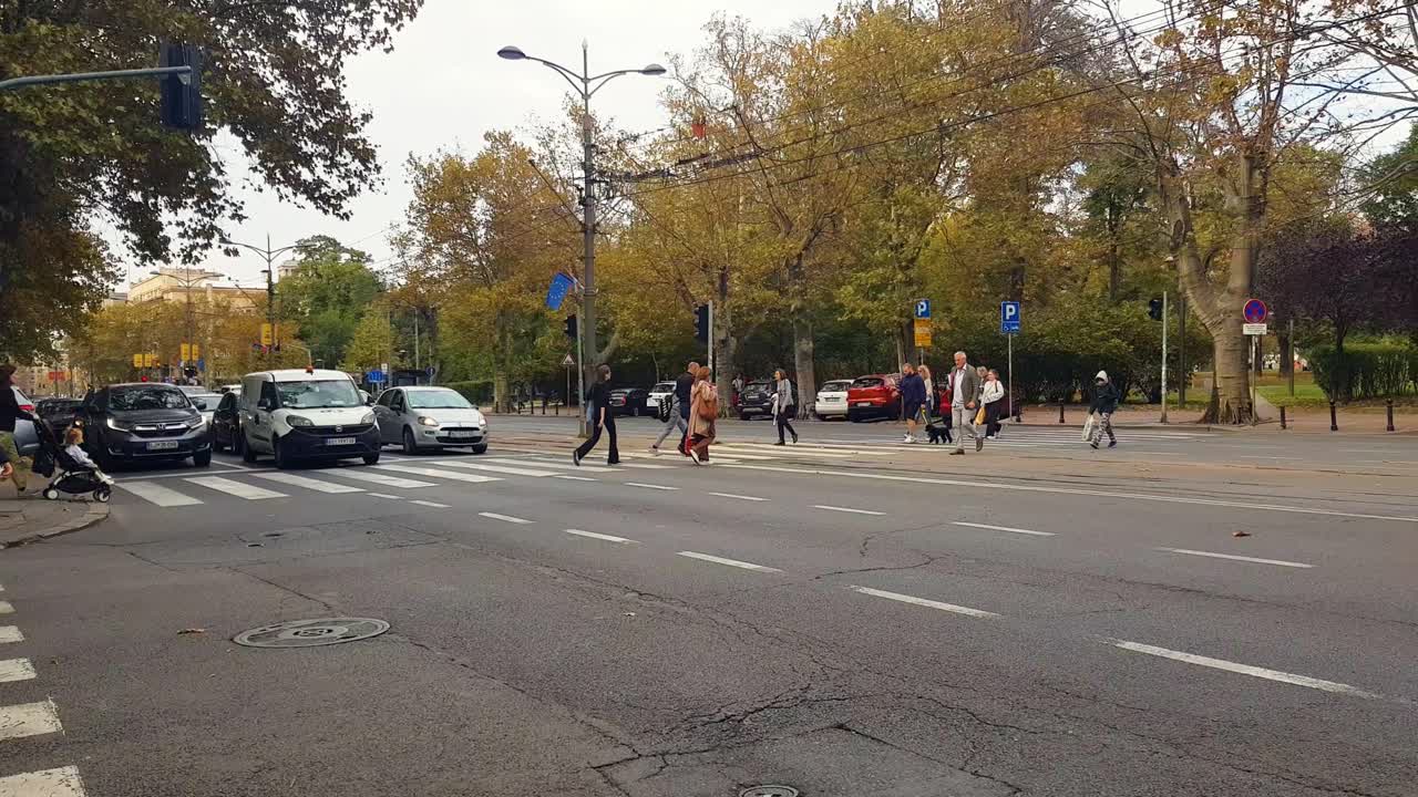 People Crossing the Street in an Autumn City