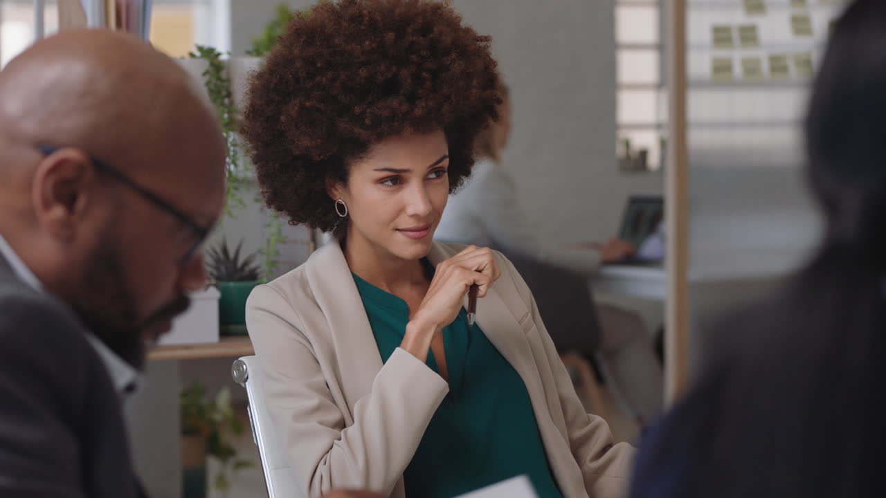 beautiful mixed race business woman team leader meeting with colleagues sharing creative ideas for company project discussing corporate strategy in office boardroom