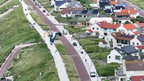 coastal town with kite flyers and residential homes