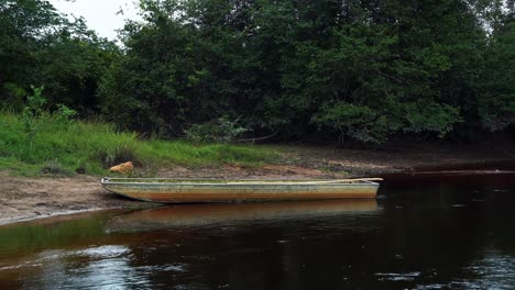 an old wooden row boat docked at the