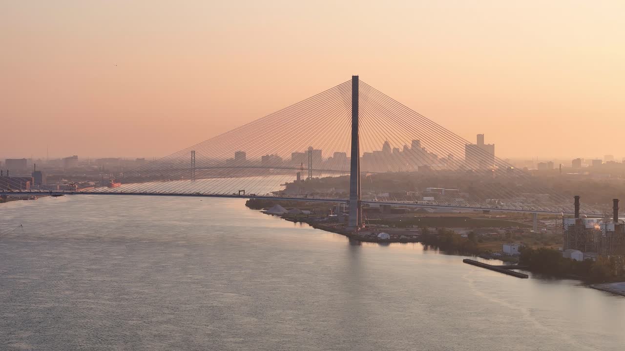 Gordie Howe International Bridge spanning Detroit River at sunrise skyline view