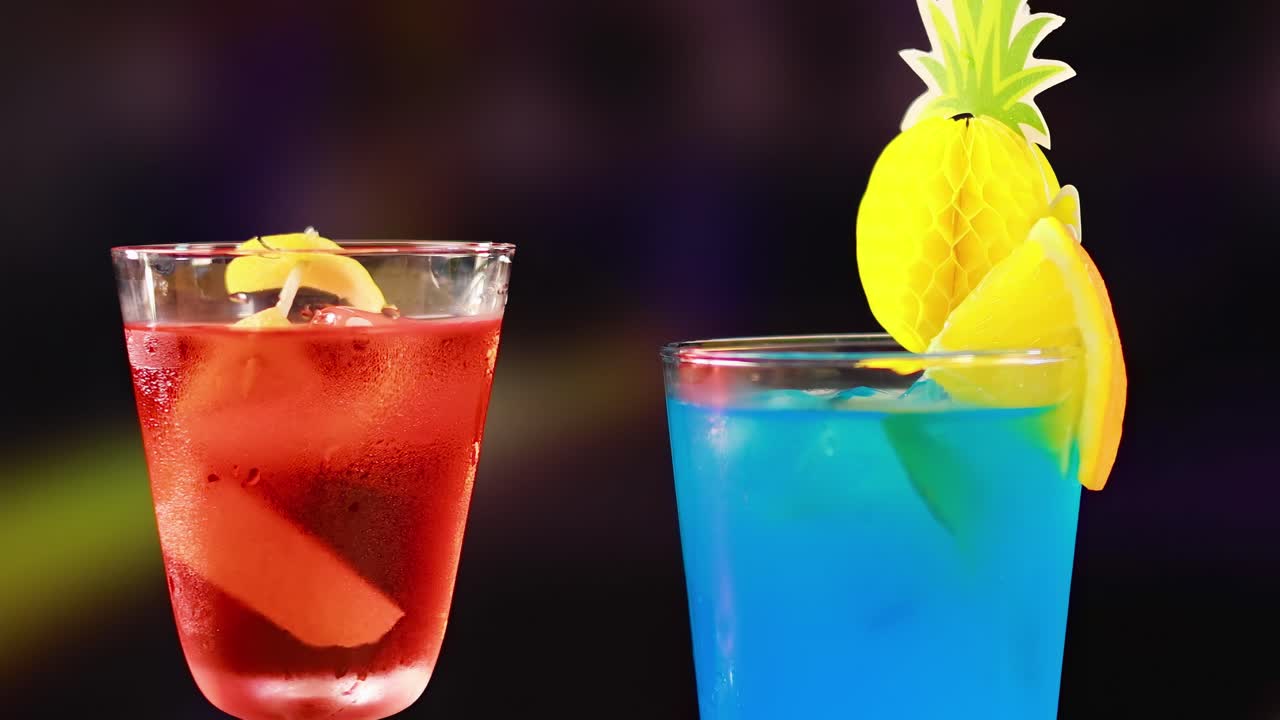 Close-up of red and blue cocktails with citrus garnishes, highlighting vibrant colors and refreshing presentation.