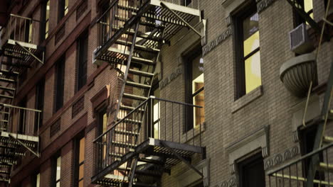 fire escapes adorn urban buildings in a twilight setting with glowing windows