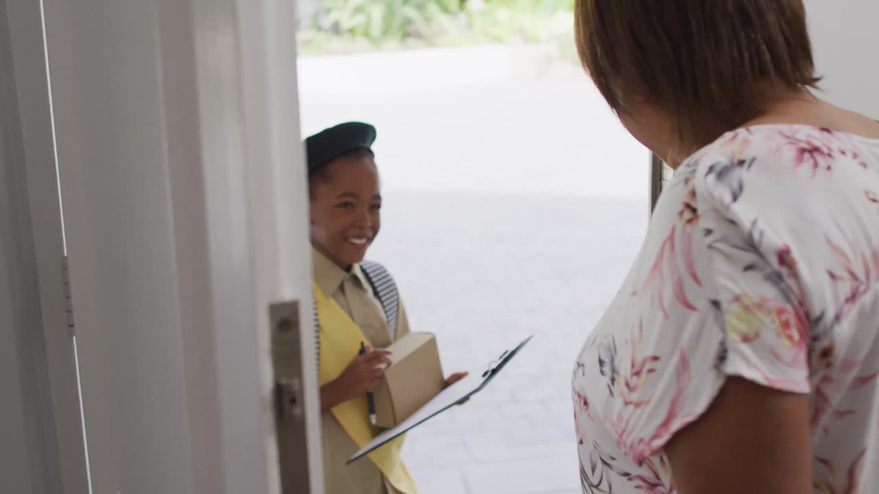 Animation of african american girl in scout costume delivering package to biracial woman