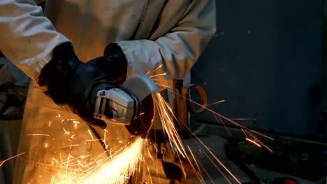 a man cuts metal with a grinder in his workshop. a man's hobby. 4k