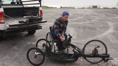 disabled man assembling parts of a bicycle