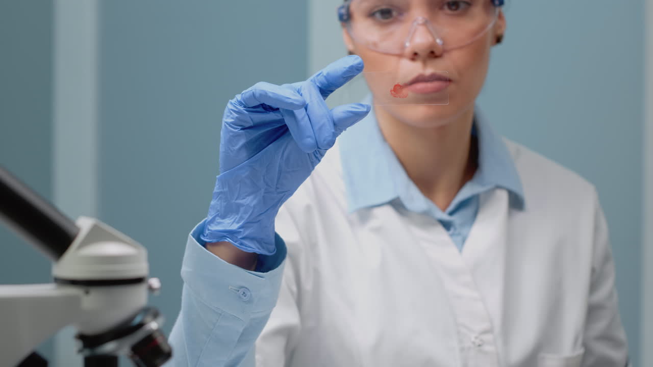 Scientist examining blood sample in lab