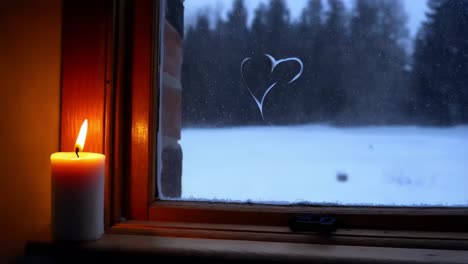 winter window with candlelight and heart