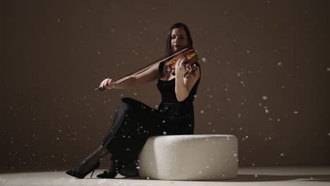 woman playing violin in winter setting