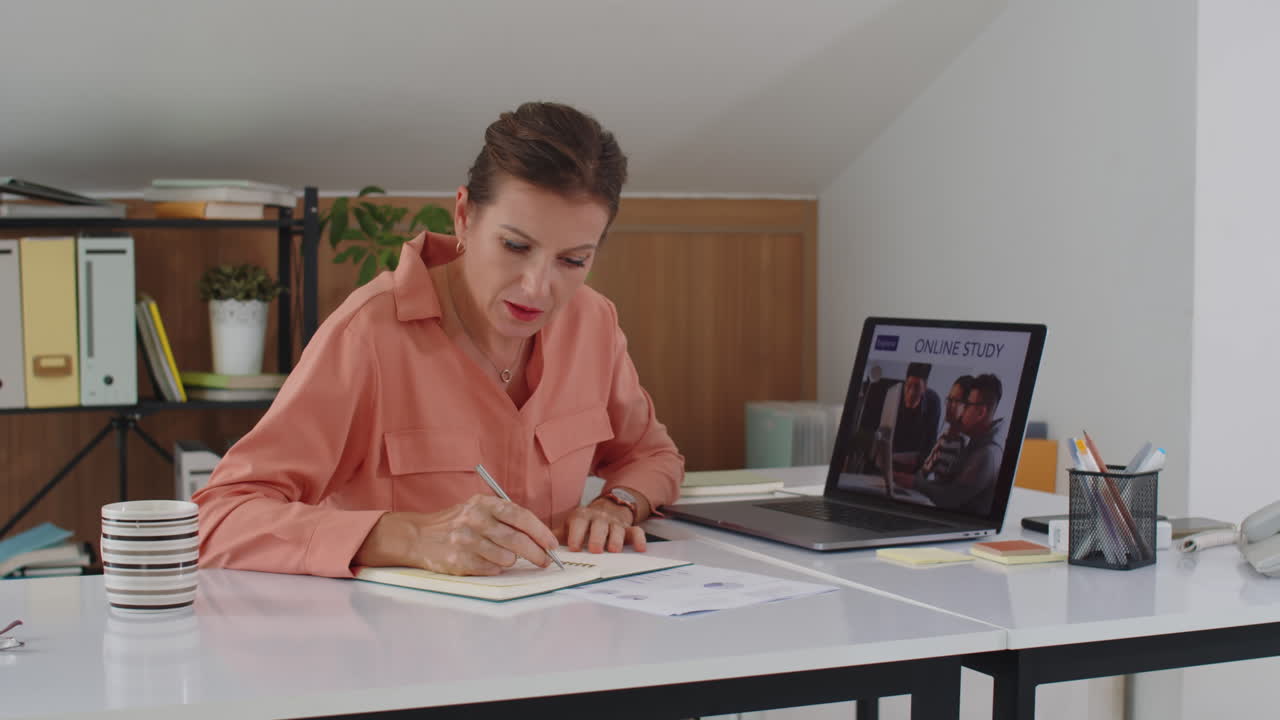 Middle-aged Businesswoman Taking Online Course during Work