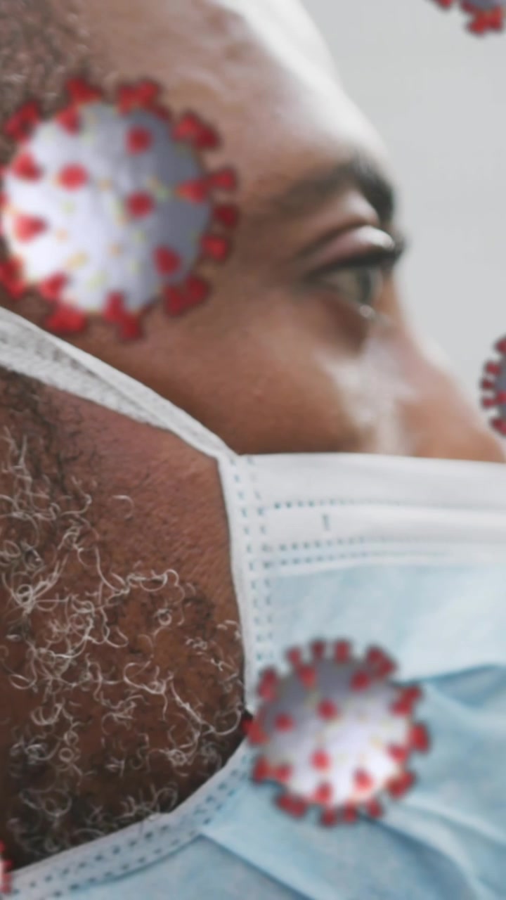 Animation of covid 19 cells over african american man wearing face mask