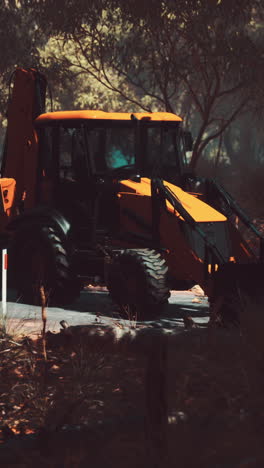 orange backhoe in a forest