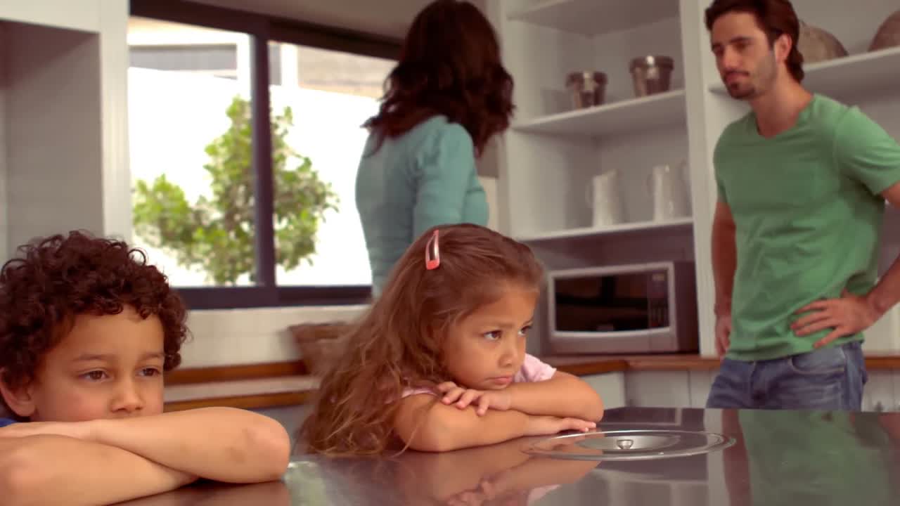 Hispanic couple disputing front of their children