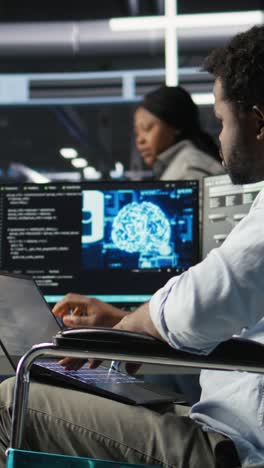vertical video data center computer scientist in wheelchair using ai node tree software