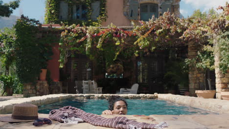 attractive woman swimming in pool at beautiful holiday villa enjoying summer vacation relaxing on warm sunny day