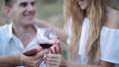 man givnig woman little red box and ring in it. handsome man giving engagement ring to a beautiful young woman
