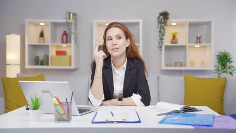 home office worker woman coming up with idea looking at camera.