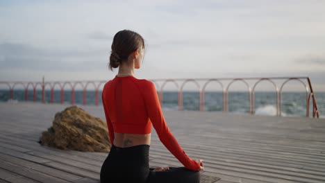 woman meditating on a beach