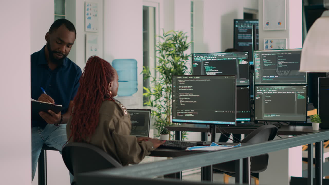 African american team of cloud programers talking about programming compiling code