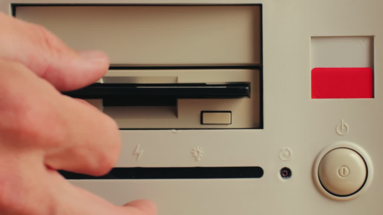 Using diskette for old computer. Music recorder, playing retro computer games. Vintage device for office, obsolete technology. . High quality 4k footage