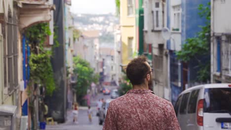 Young-man-walking-on-historic-cobblestone-streets.