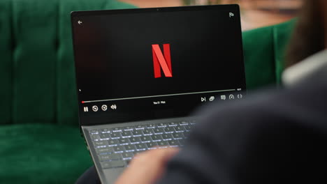 vertical video bucharest, romania - july 30th 2024 - young ceo using netflix to relax in office