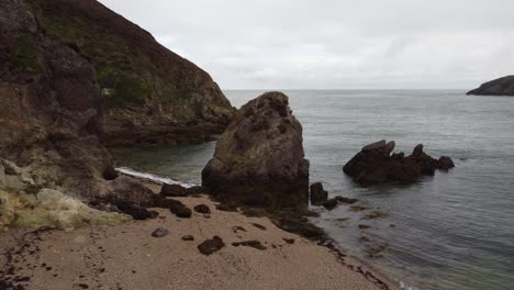 Crane-Shot-Of-Distinctive-Seascape-Scenery-Porth-Wen-Beach,-United-Kingdom