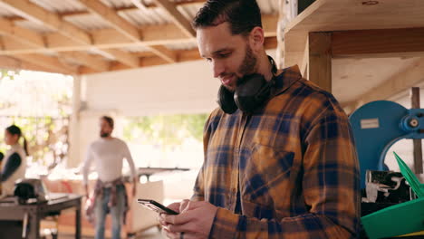 Carpenter-man,-phone-and-texting-in-workshop