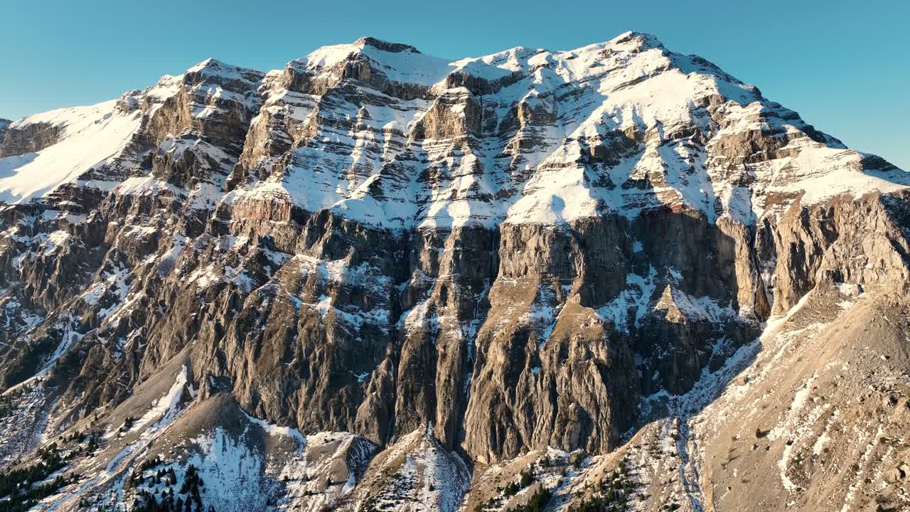Flying away from a snow covered mountain