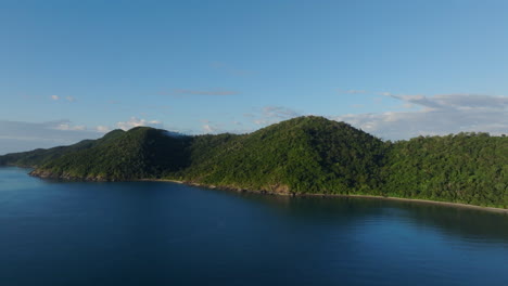 aerial drone shot ascending slowly over the ocean near long island in the whitsundays, australia