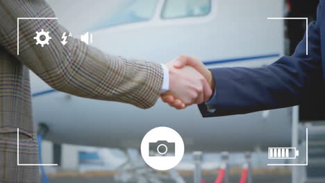 taking photos of businessmen shaking hands on a digital camera