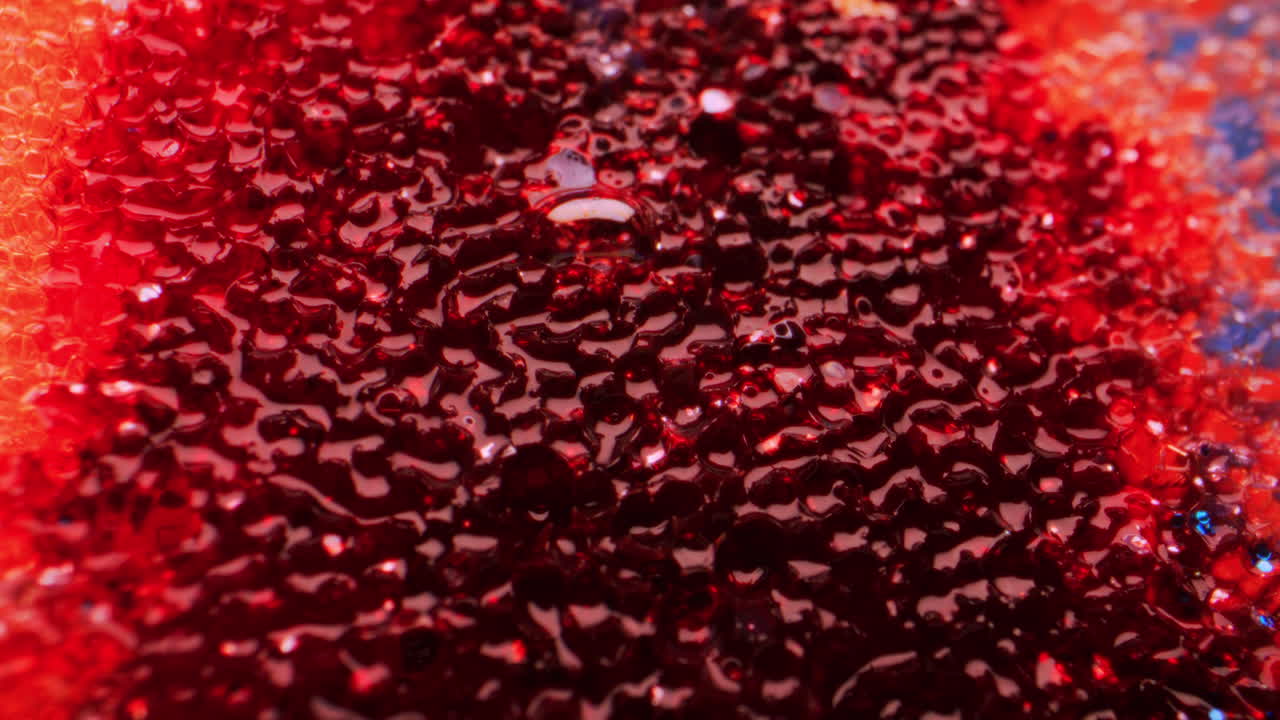 Close-up view of a red, textured surface with glitter