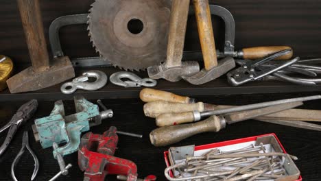 various old tools lie on a wooden rack