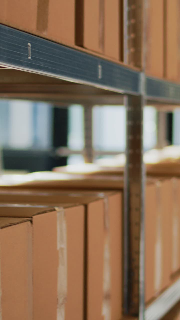 Vertical video: Racks and shelves filled with packages in storage room