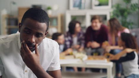 man alone at a party