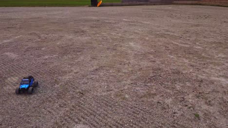 a miniature 4wd electric truck competes over rough terrain, guided remotely by a radio-controlled engine